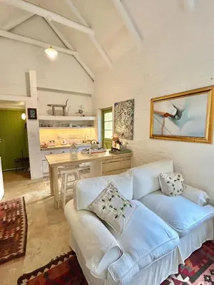 a living room with a white couch and a table at The Annex in Pringle Bay