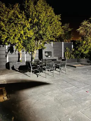 a group of chairs and a table in a patio at Mila Lodge 1 in Cape Town
