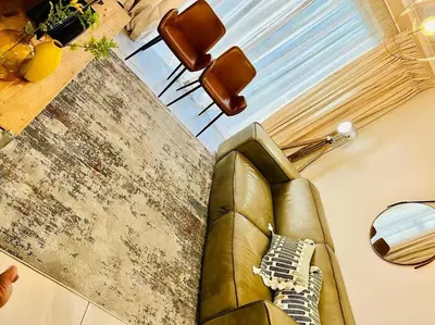 a living room with a couch and a table at Modern charm in Pinelands in Cape Town