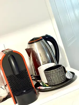 a tea pot and a tea kettle on a counter at Modern charm in Pinelands in Cape Town
