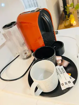 a kitchen counter with a toaster and cups on it at Modern charm in Pinelands in Cape Town