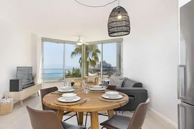 a dining room with a table and chairs and a kitchen at Welgelegen 608 in Strand