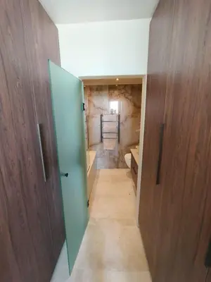 a bathroom with a green door and a toilet at Dolphin Beach beachfront apartment, 3 bedroom-6 persons in Cape Town