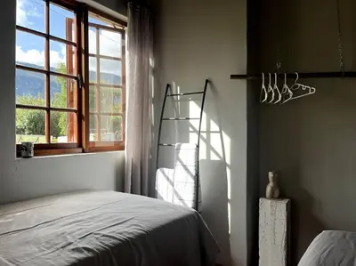 a bedroom with a bed and a window at Comfy Greyton Cottage for Four in Greyton