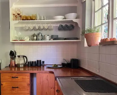 a kitchen with a sink and a counter top at Comfy Greyton Cottage for Four in Greyton