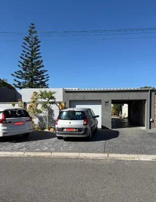 two cars parked in front of a garage at Coastal House - 2BR and Self catering in Cape Town