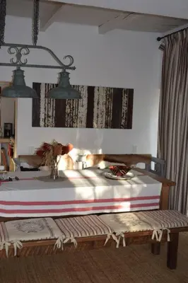 a bedroom with a bed and a bench in a room at Petite France:luxury thatched 4BRcottage with pool in Franschhoek