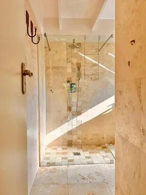 a shower with a glass door in a bathroom at Petit Casa Central Stellenbosch in Stellenbosch