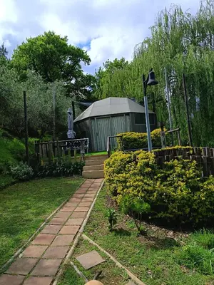 a garden with a building in the background at Glamping at The Well in Franschhoek in Franschhoek