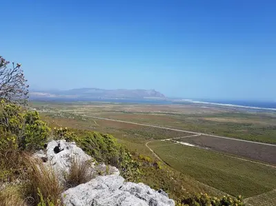 a view from the top of a hill with a large rock at Witteklip self-catering farm in Kleinmond