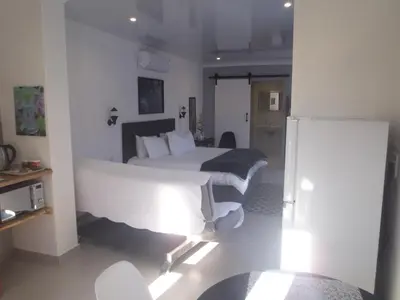 a hotel room with two beds in a room at Mi Amor Accommodation in Brackenfell