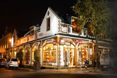 a store front of a building at night at The Lookout Loft, a short stroll into town in Stellenbosch