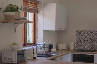 a kitchen with a sink and a microwave at Three Streams Cottages in Franschhoek