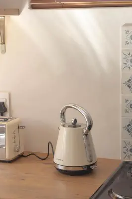 a tea kettle sitting on a counter next to a toaster at Three Streams Cottages in Franschhoek