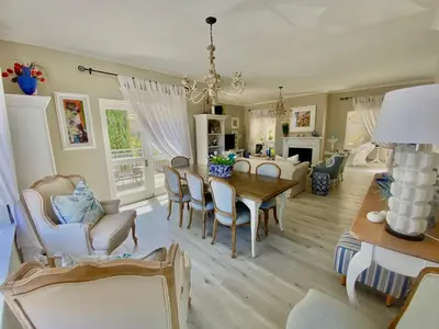a dining room and living room with a table and chairs at Ocean and mountain breeze in Hermanus