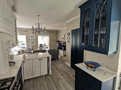 a kitchen with blue cabinets and a counter top at Ocean and mountain breeze in Hermanus