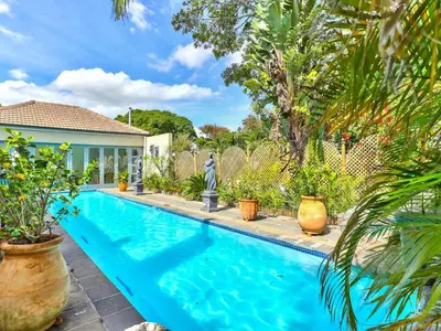 a swimming pool in a yard with plants at Villa Jesdene in Cape Town