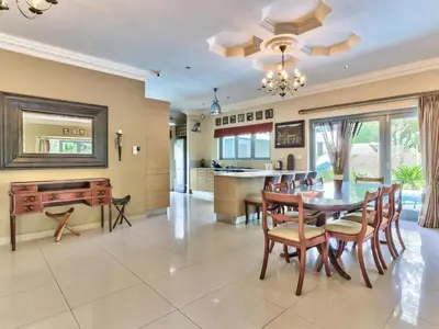 a dining room and kitchen with a table and chairs at Villa Jesdene in Cape Town