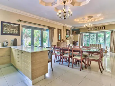 a kitchen and dining room with a table and chairs at Villa Jesdene in Cape Town