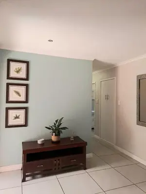 a living room with a couch and a table at Cosy and Central Family Home in Cape Town