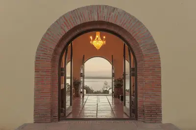 an archway leading into a building with a chandelier at Southwinds Estate in Hermanus