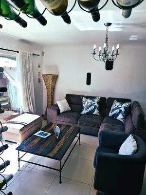 a living room with a couch and a coffee table at Regent Casa’s in Cape Town