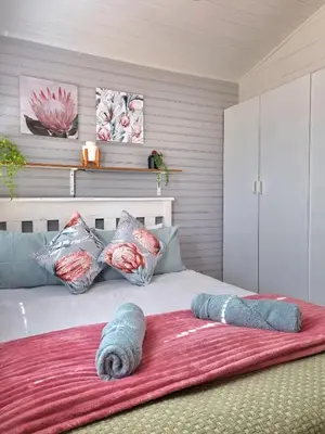 a bedroom with a large bed with a red blanket at 81 Kingfisher in Lake Marina