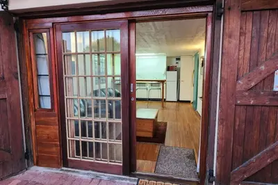 an entrance to a room with a wooden door at De Kelder in Cape Town