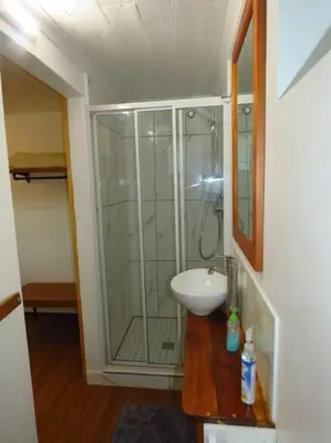 a bathroom with a shower and a sink at De Kelder in Cape Town